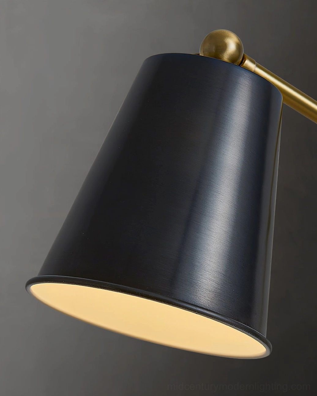 Tresa brass conical shade and arm joint detail close-up matte black metal construction