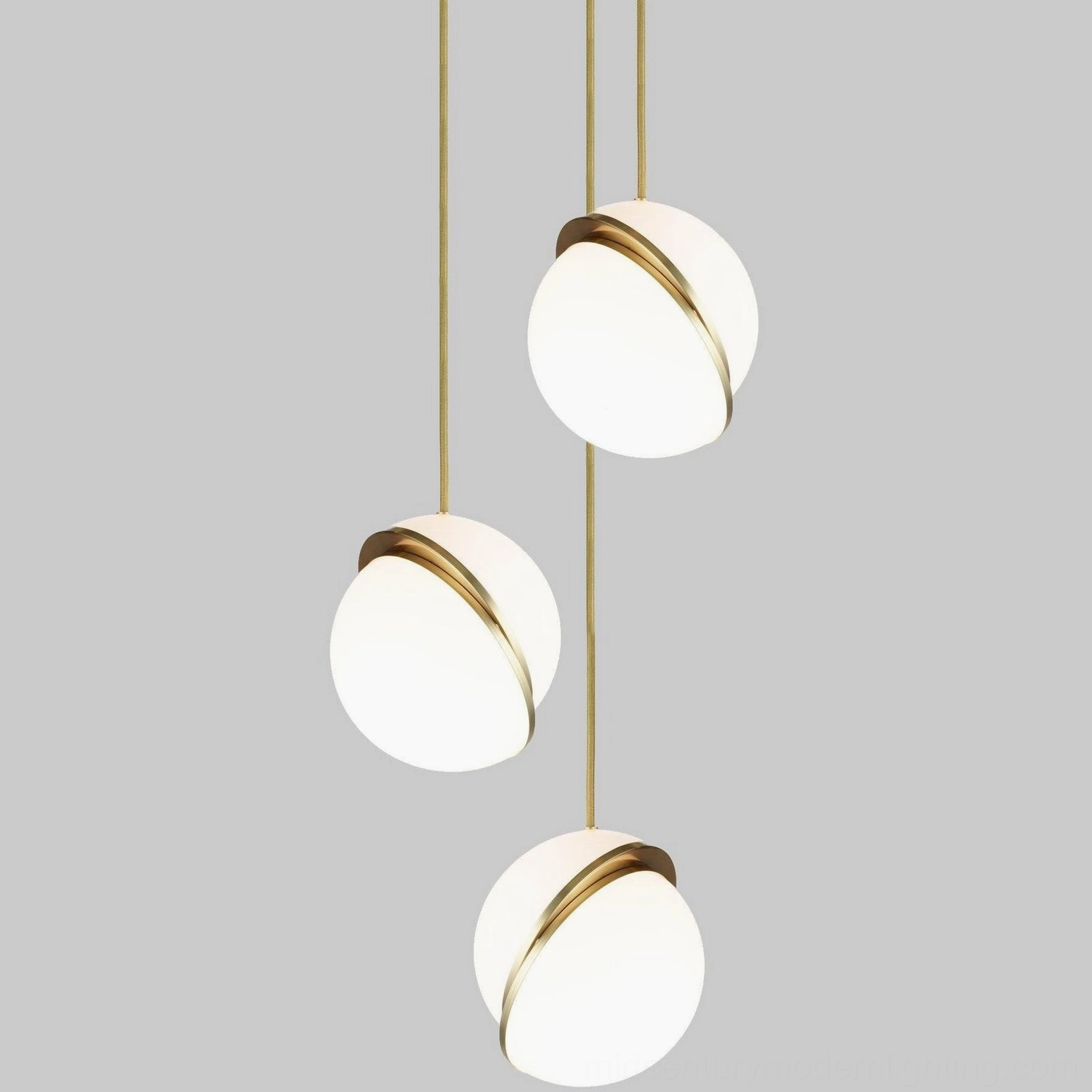 Three-head crescent pendant light fixture with spherical shades and brass suspension cords