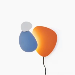 Tria plug-in wall lamp front view showcasing matte tri-color finish with orange and black geometric design