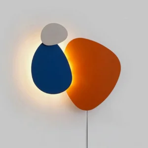 Tria modern wall lamp overhead perspective with soft backlit glow and sculptural surface detail