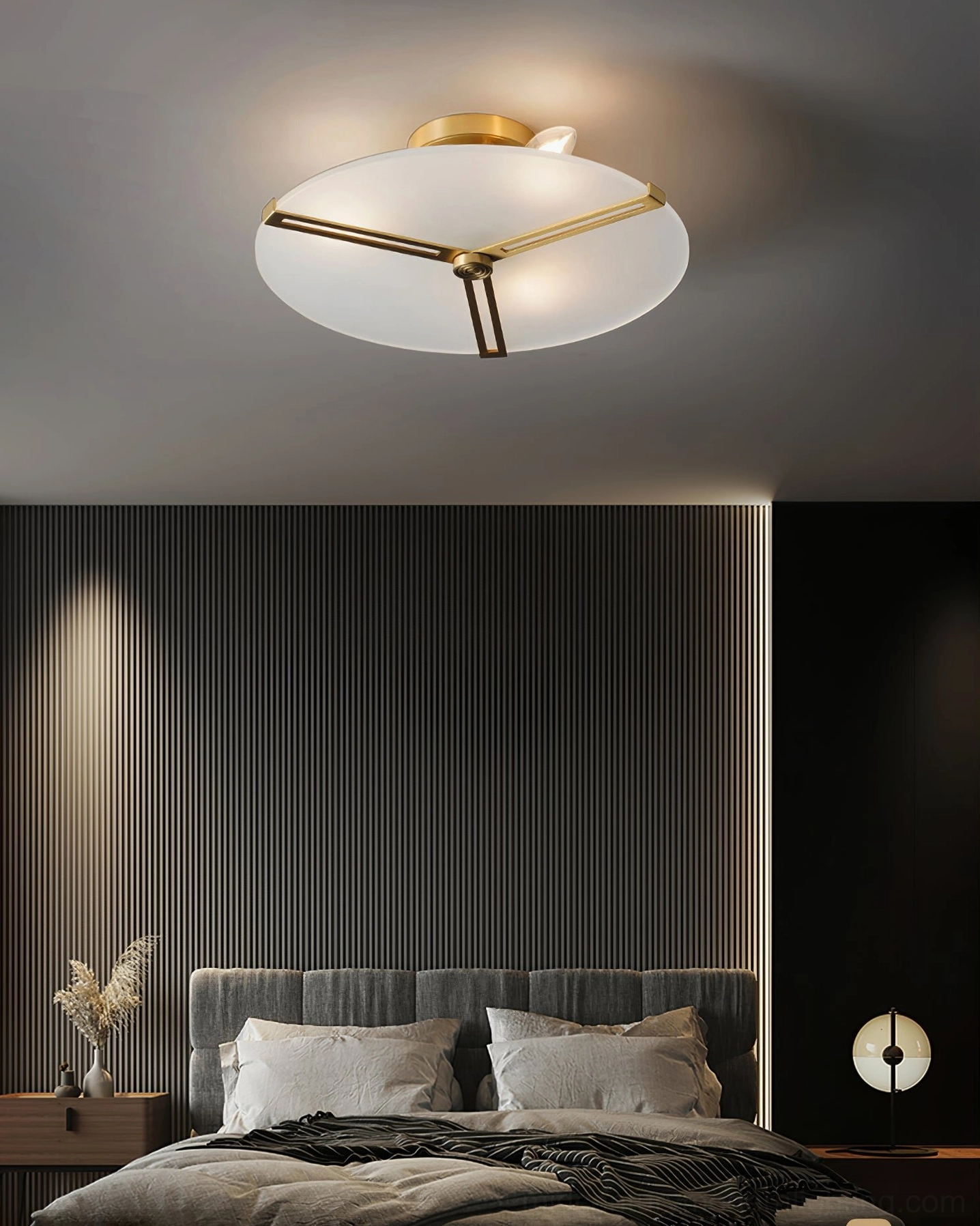 Triangular brass frame ceiling lamp installed in clean architectural ceiling space
