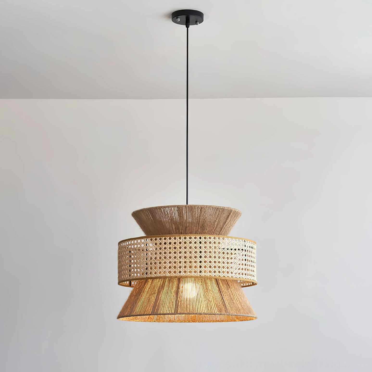 Three-tier rattan pendant light with black ceiling mount rod and natural woven material finish
