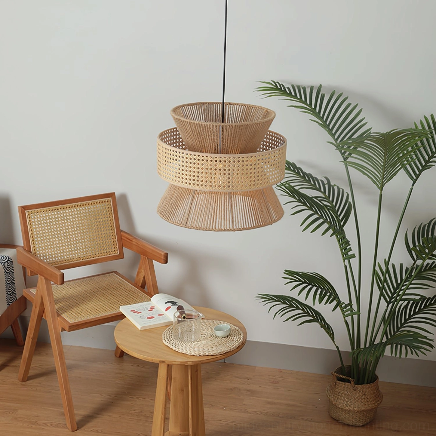 Woven rattan pendant shade with black hanging cord and two-part design in minimalist bohemian interior