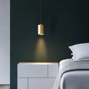 Brass trio pendant lamp hanging in modern bedroom with dark green accent wall - mid-century lighting