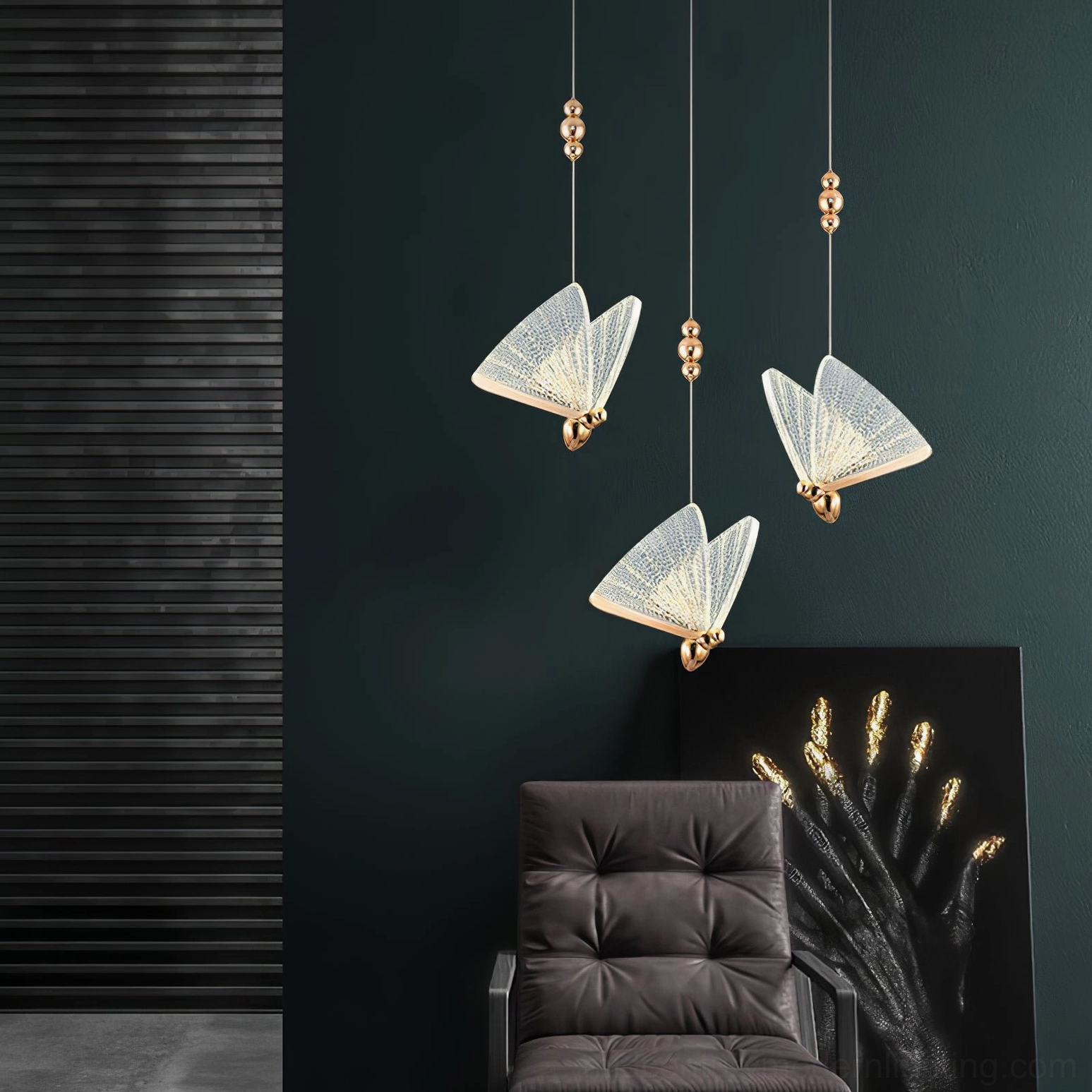 Three butterfly pendant lights in modern lounge with dark green wall and tufted leather seating