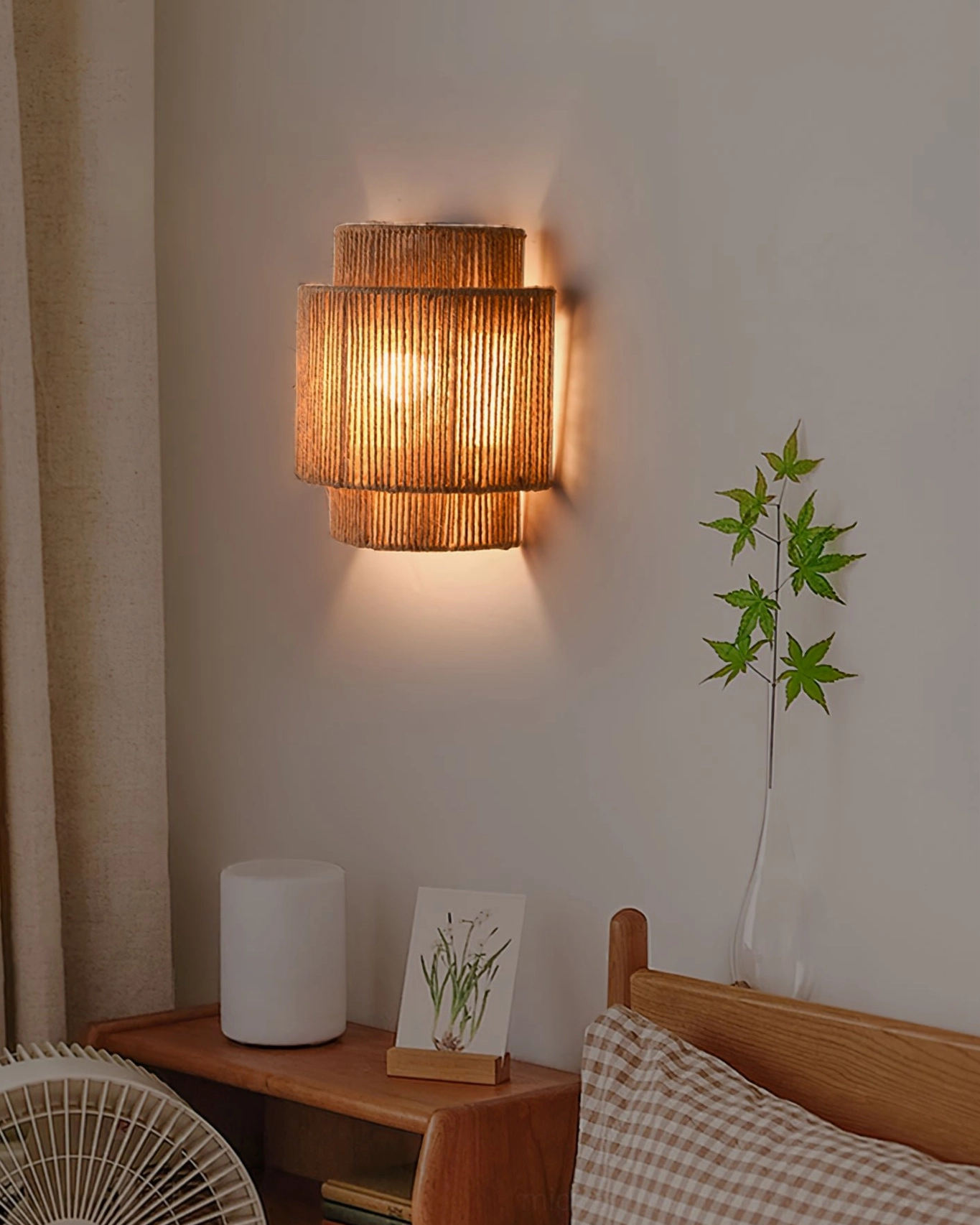 Artisanal handwoven rope wall sconce, tiered cylindrical design with natural jute material
