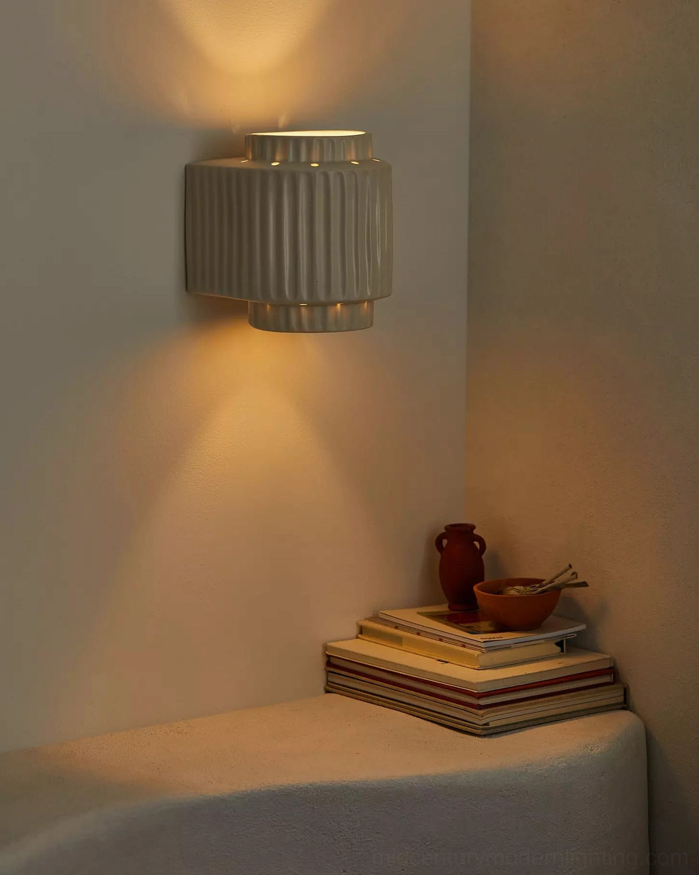 Tristan architectural wall lamp installed in stylish bedroom featuring minimalist design aesthetic and warm lighting