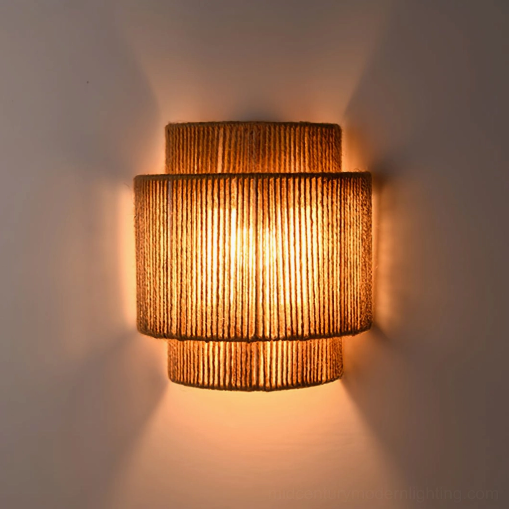 Lit Tristan tiered rope wall sconce with soft warm bohemian ambient lighting, close-up frontal shot