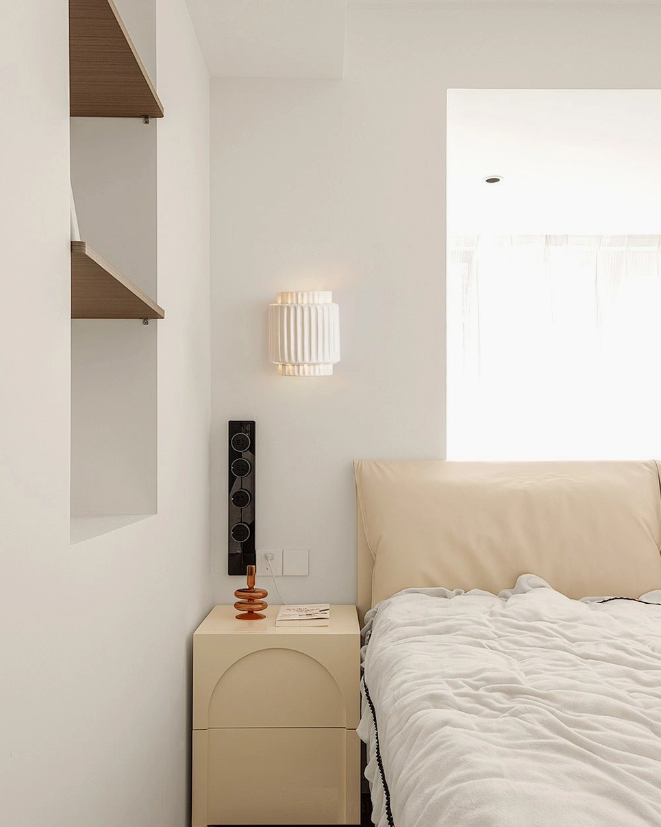Tristan architectural wall sconce lighting minimalist bedroom with curved nightstand and floating shelves modern design