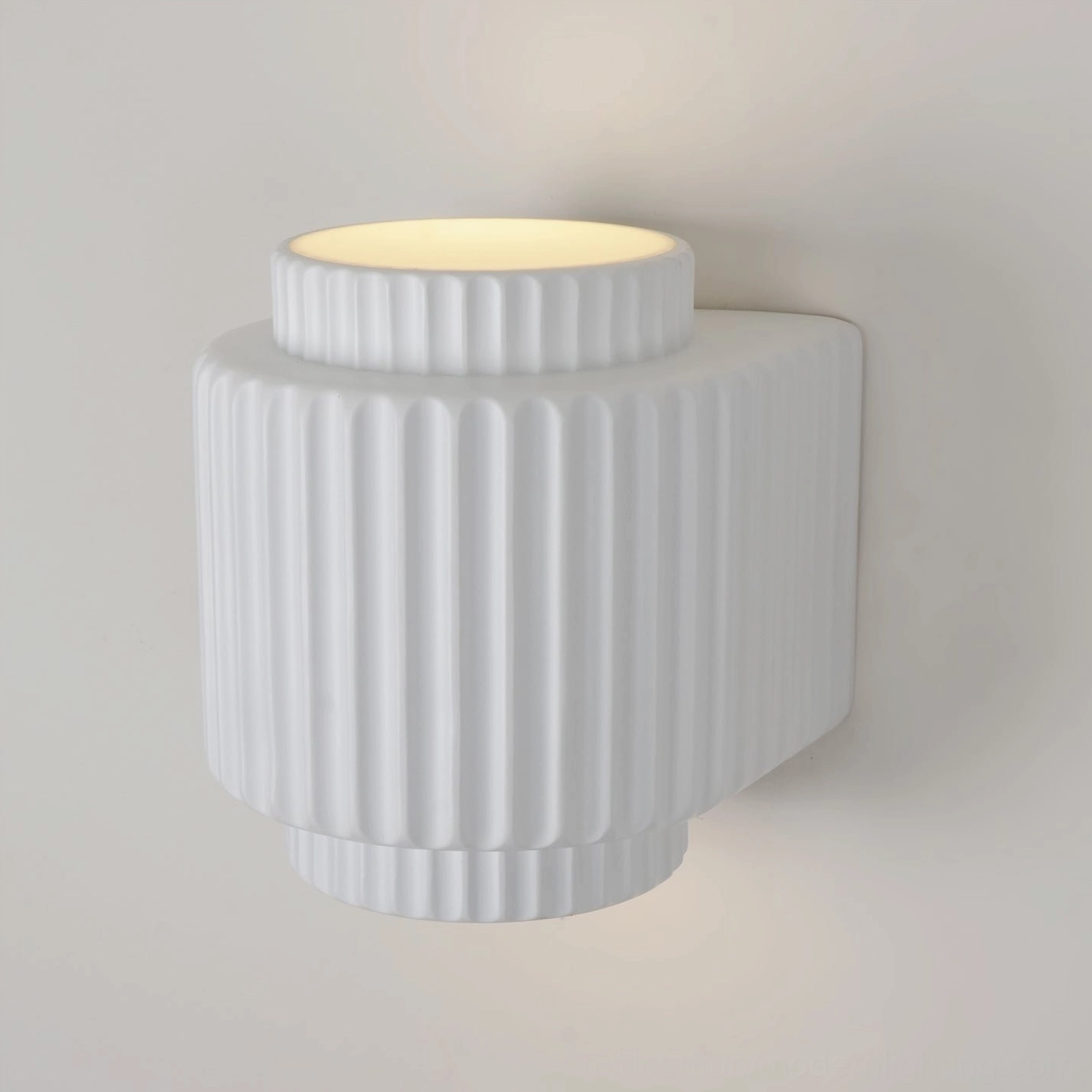 Tristan fluted wall sconce close-up detail of small ribbed ring and flat body with vertical grooves texture