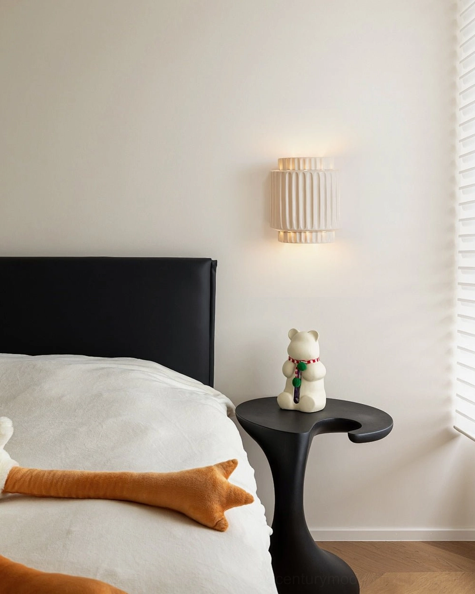 Tristan geometric ribbed wall sconce mounted as accent lighting in modern bedroom interior styling