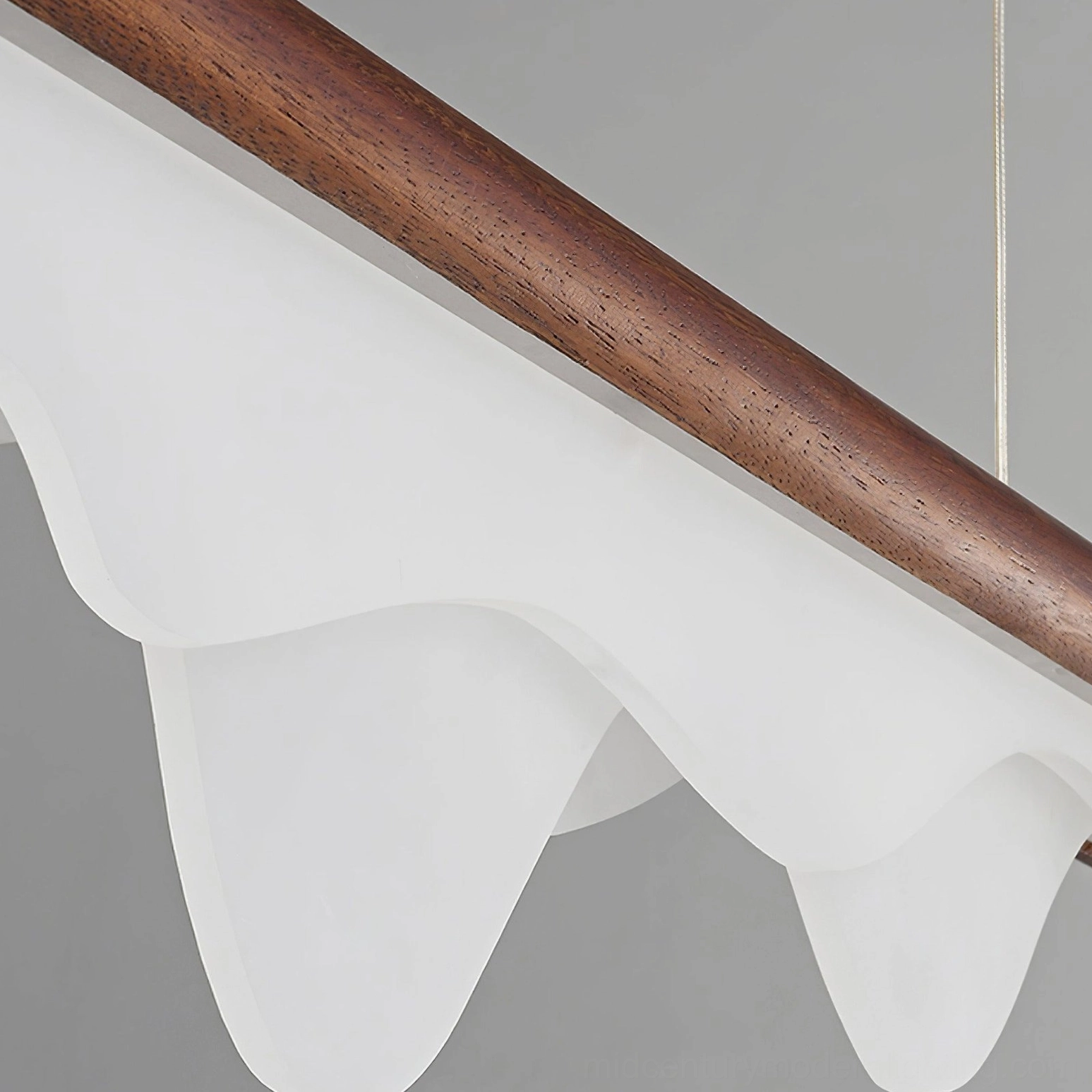 Close-up of Troag acrylic diffuser and walnut suspension rod, frosted mountain-shaped shade