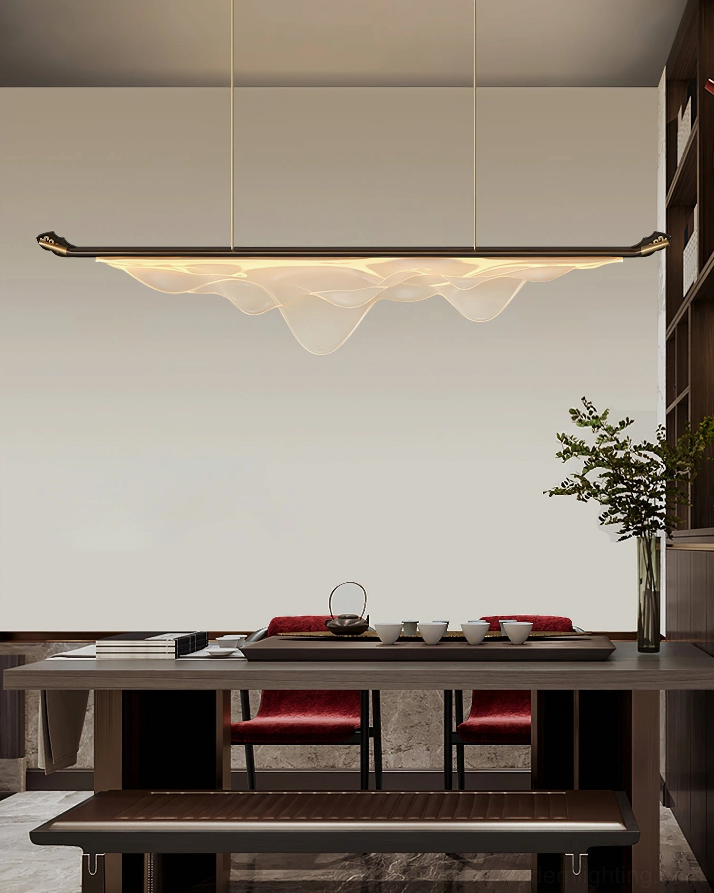 Troag modern pendant fixture above formal tea room with red upholstered chairs and plant