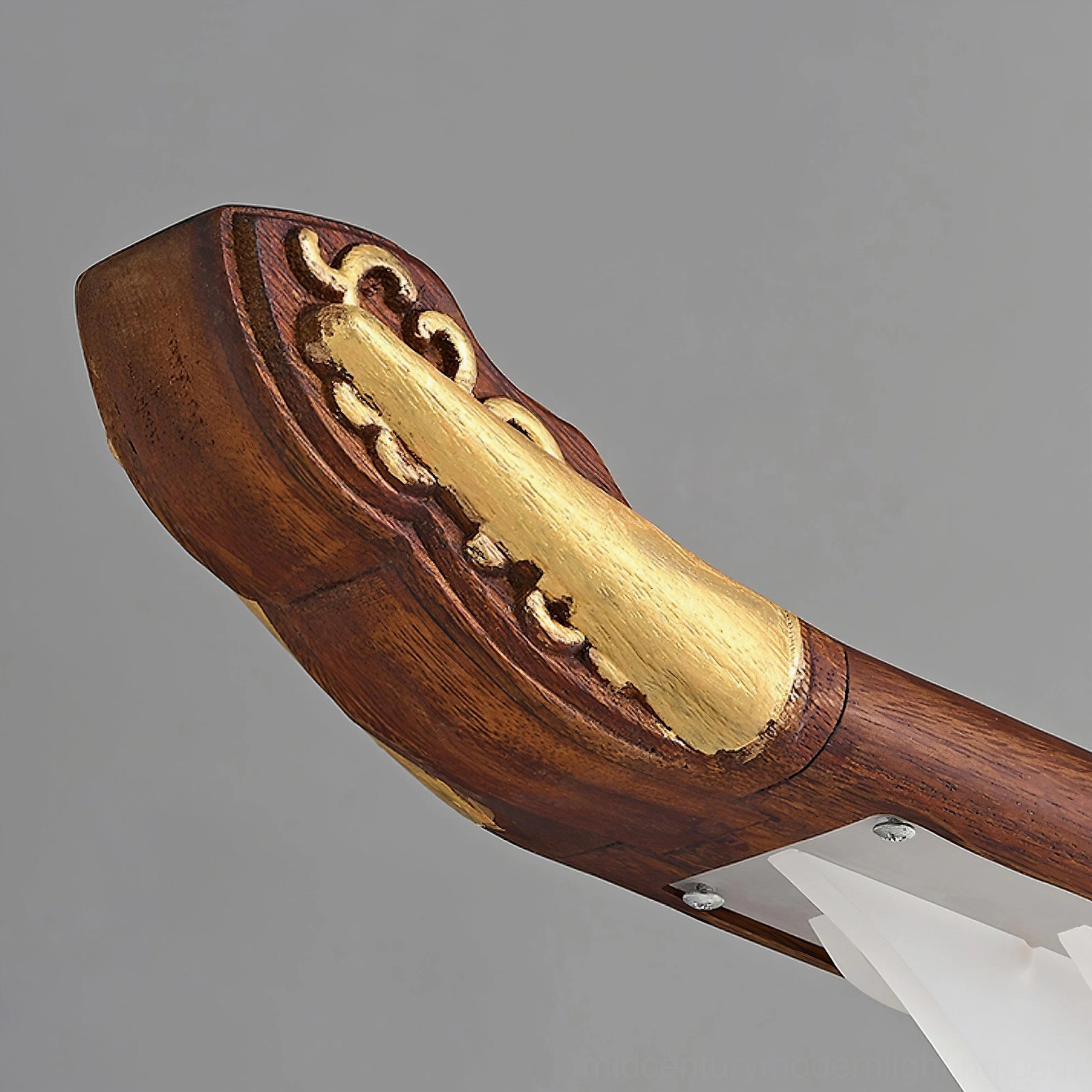 Close-up detail of Troag pendant light end cap, walnut wood with traditional carved pattern