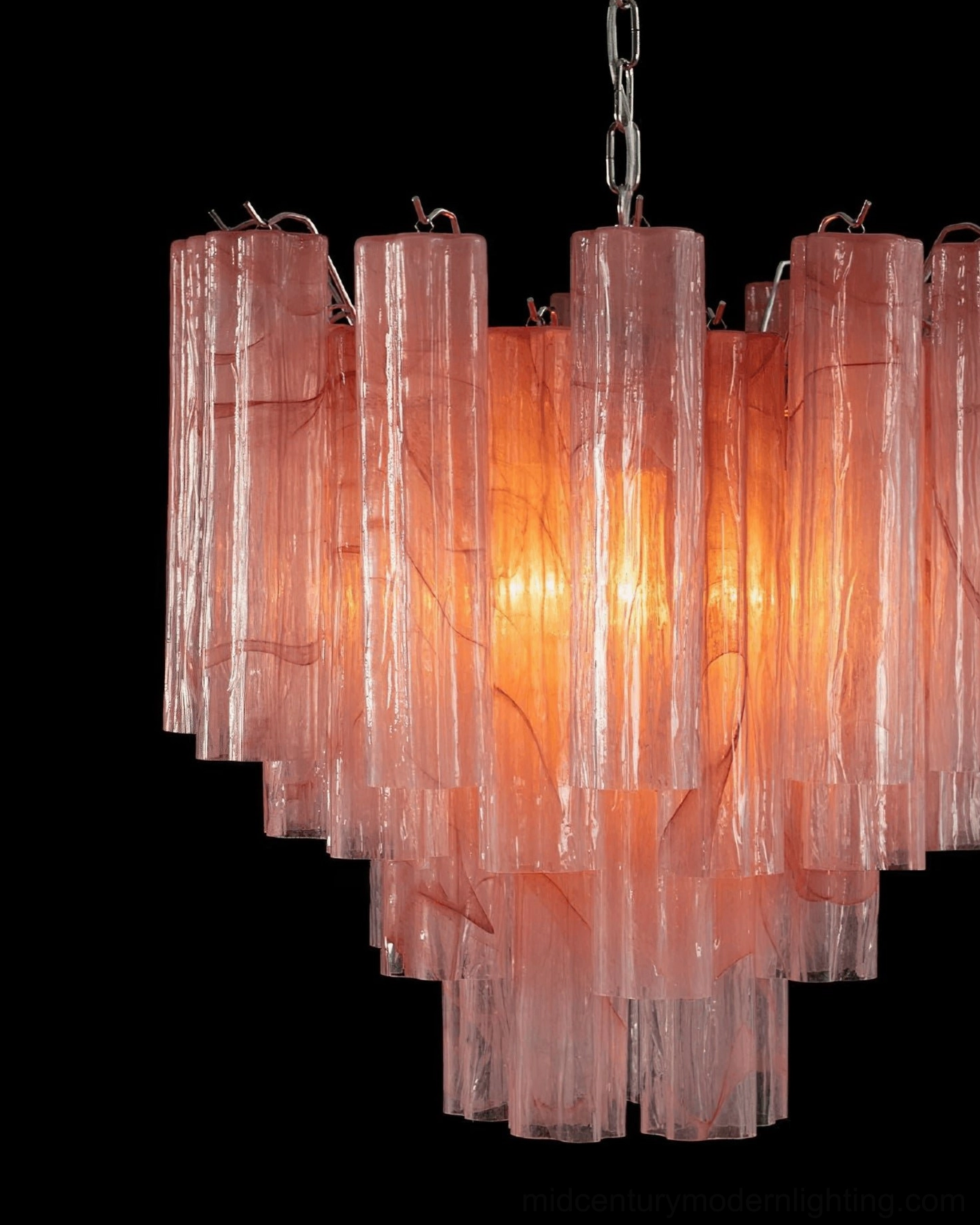 Tronchi pink marbled glass chandelier with bright warm glowing light creating ambient atmosphere, angled frontal perspective