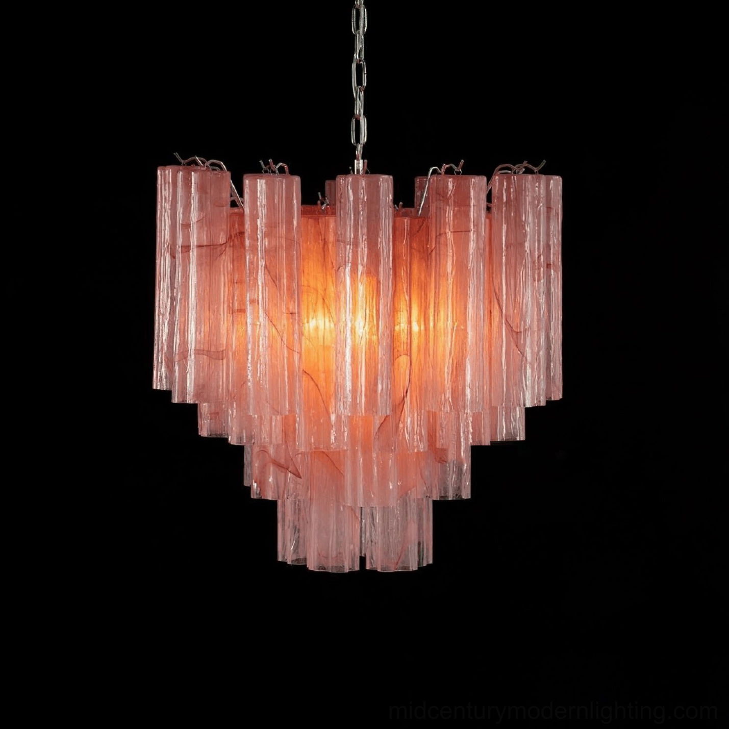 Pink tiered glass tube chandelier illuminated with warm interior light against black background, modern cascade design