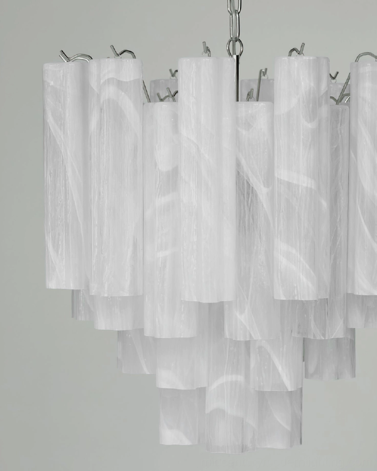 Close-up detail of Tronchi chandelier showing marbled white glass tubes and two-tiered layered structure with metal fixtures