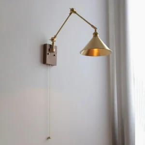 Troy Swing Arm Wall Lamp three-quarter view illuminated brass dome shade walnut base pull chain