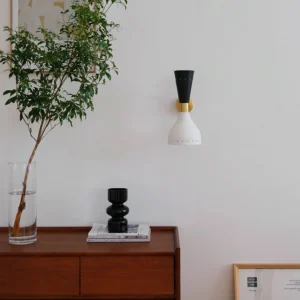 Tuba wall sconce installed in Nordic minimalist bedroom above bedside creating ambient accent lighting