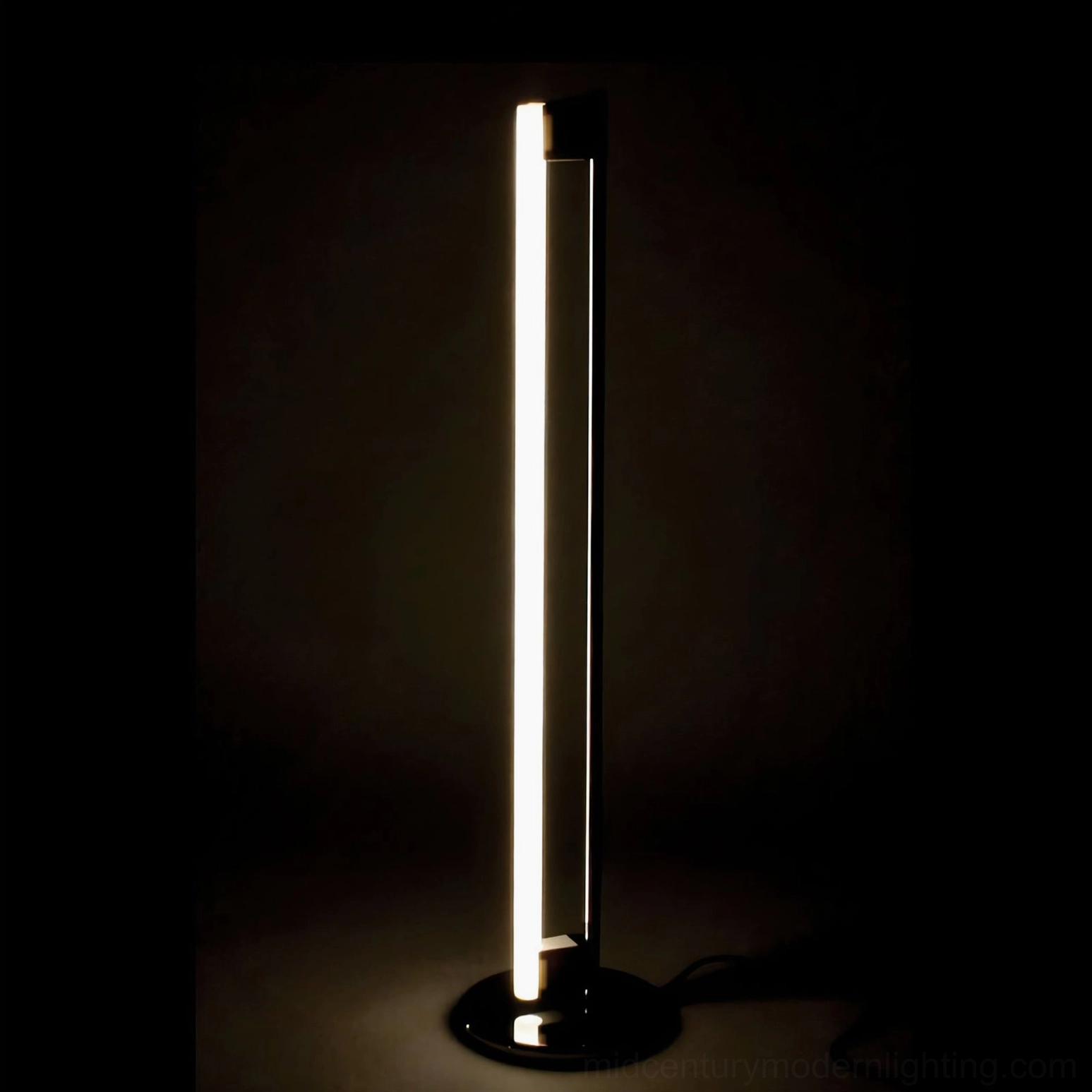 Minimalist tube LED floor lamp architectural detail showing chrome base stability and acrylic light diffusion