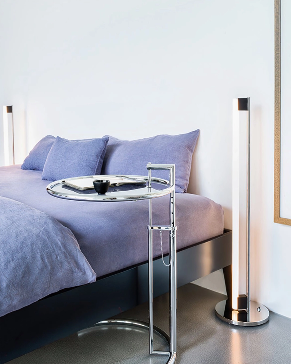Contemporary chrome tube lamp creating vertical interest in narrow hallway or foyer space