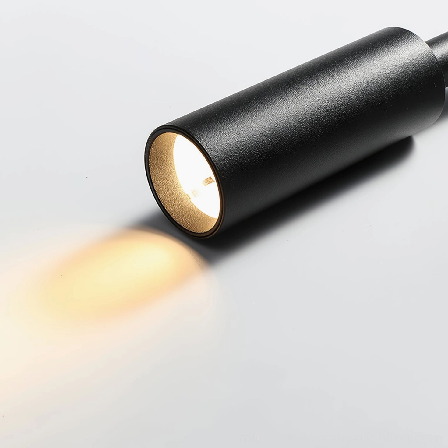 Tubino black wall lamp head frontal view matte metal cylinder warm LED beam