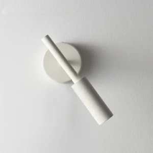 Tubino white LED wall sconce side close-up mounted on textured wall interior design display