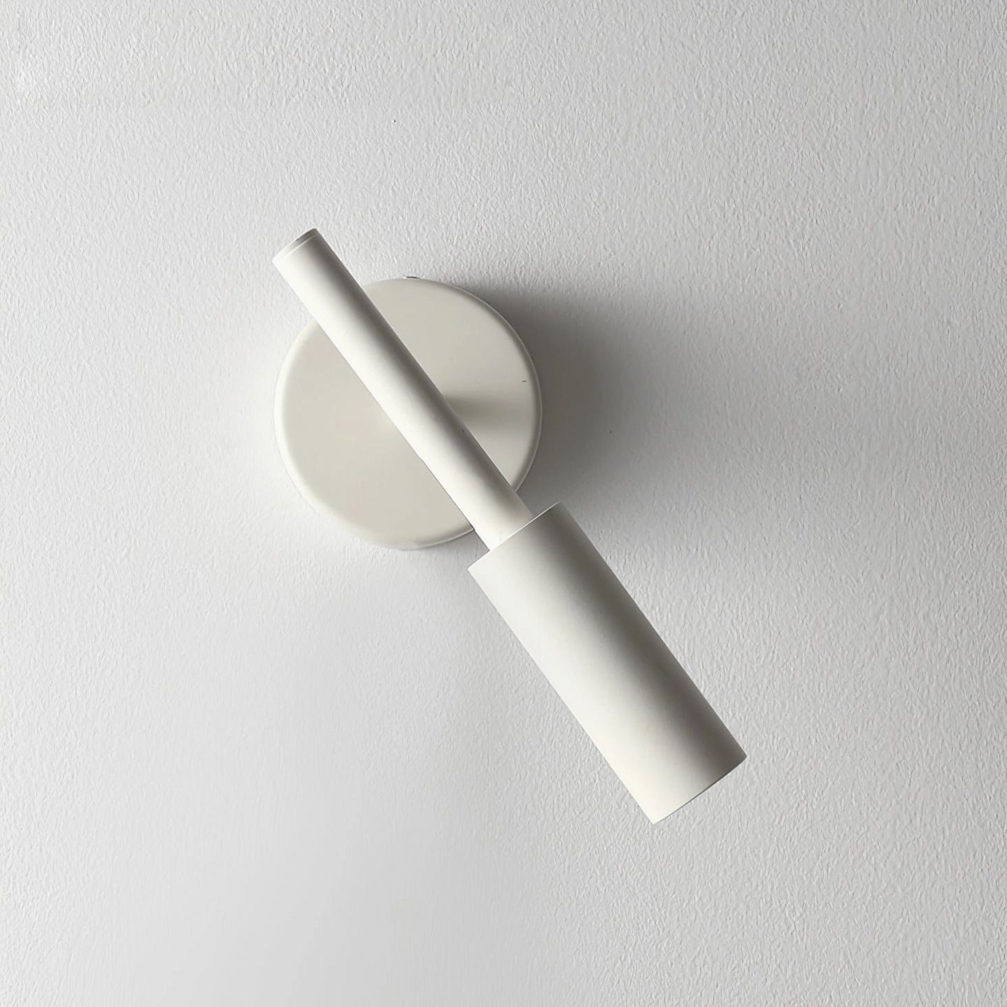 Tubino white LED wall sconce side close-up mounted on textured wall interior design display