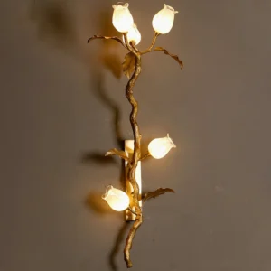 Tulip Branch Brass Wall Sconce lit overhead perspective with warm LED glow illuminating frosted glass tulips against neutral wall