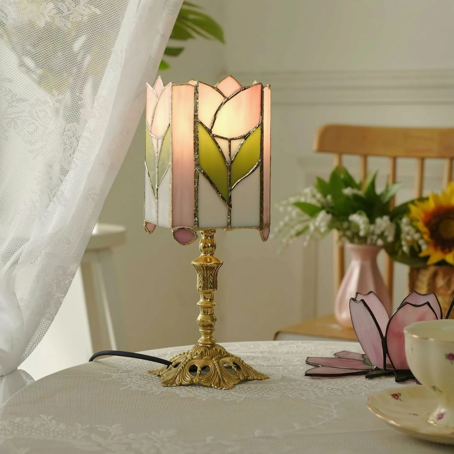 Pink and green tulip stained glass lamp on vintage dining table with lace tablecloth and romantic home decor