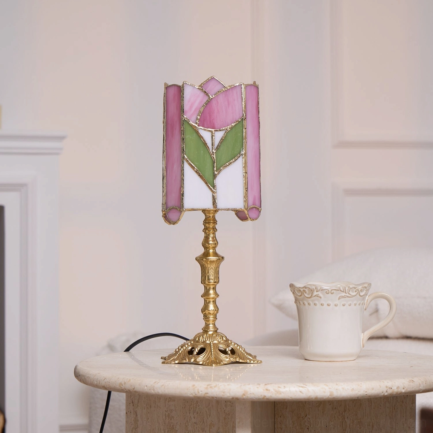 Tulip stained glass bedside table lamp on side table with white sofa and ceramic mug in living room