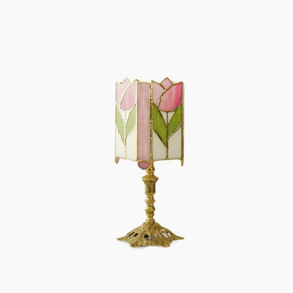 Tulip Tiffany stained glass table lamp with pink tulip shade and ornate brass base, front view on white background