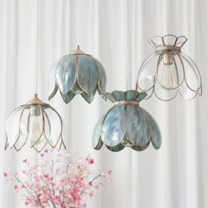 Multiple Turrella petal pendant lights in various glass finishes hanging in studio with sheer curtains