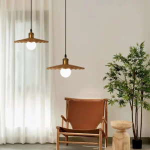 Two walnut geometric pendant lights in minimalist living room with sheer curtains, brown leather chair, and green plant - Japandi interior design