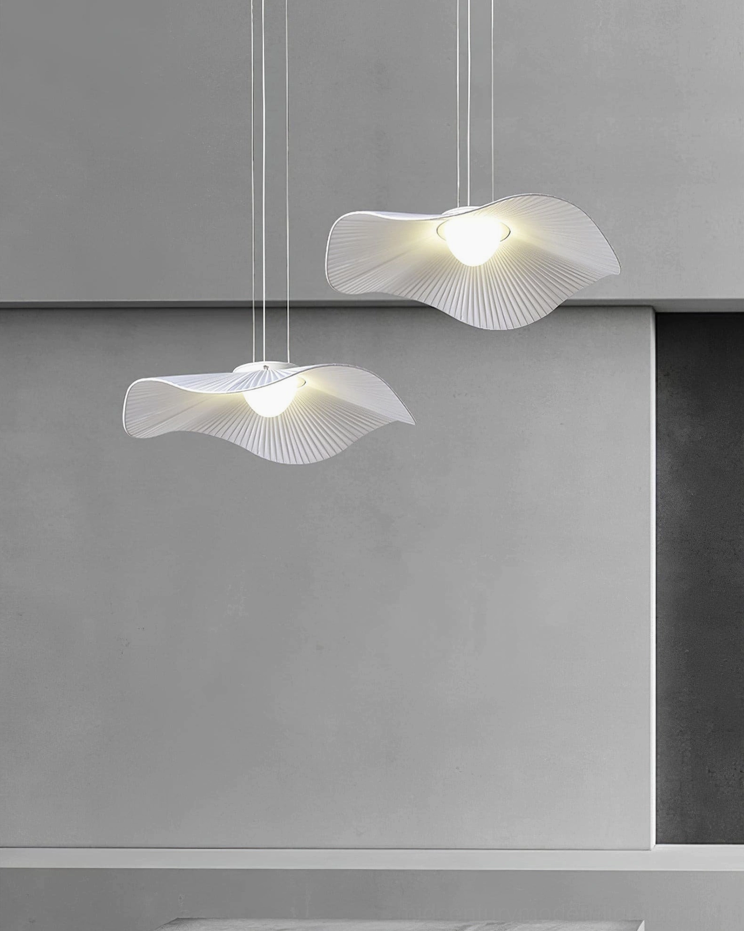 Two matching white cloud pendant lamps suspended at different heights studio setting
