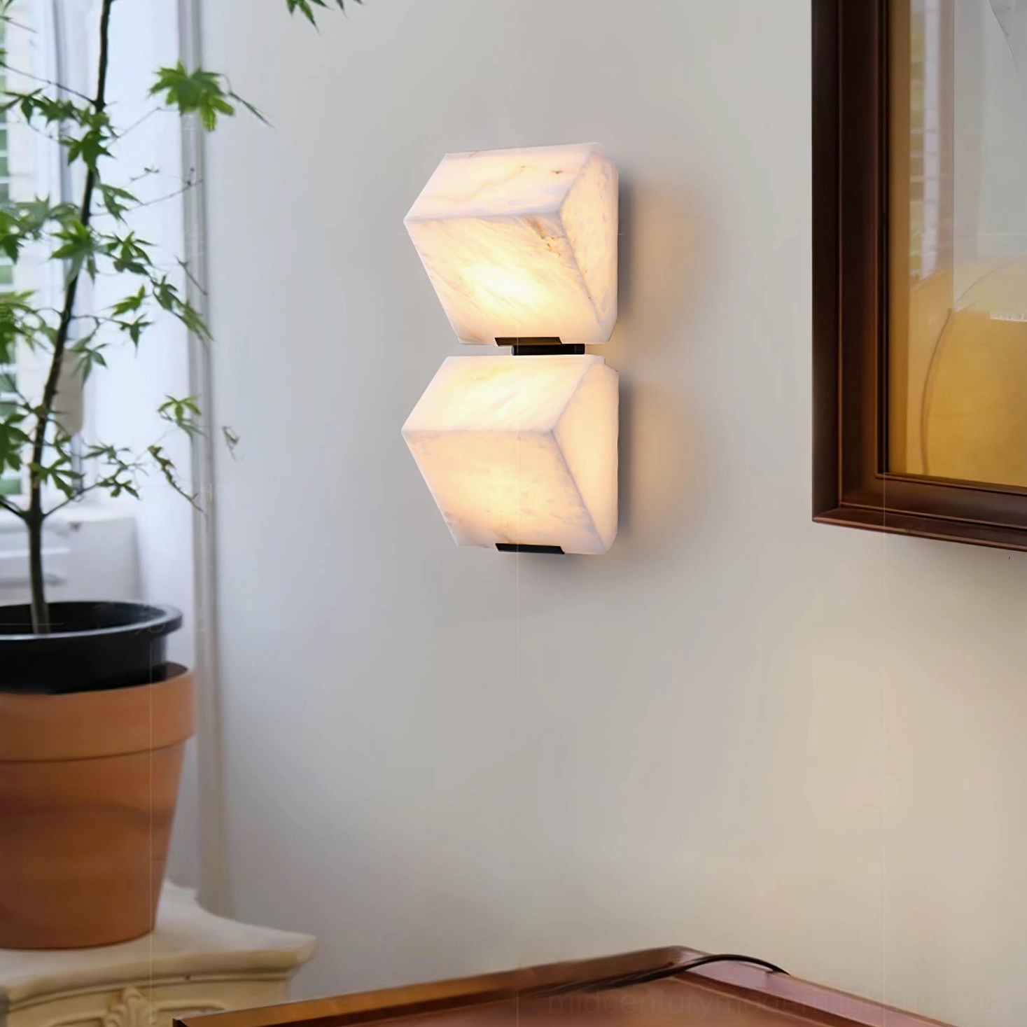 Double-stacked alabaster wall lamp installed in entryway with decorative frame, modern minimalist lighting design