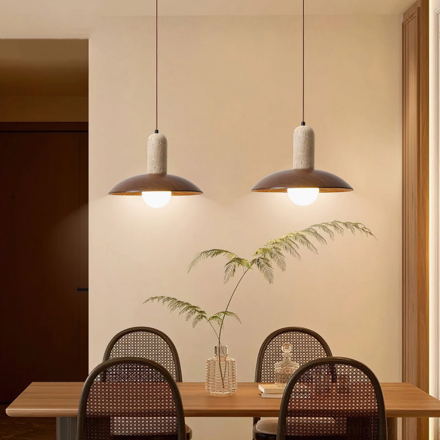 Dual molly pendant lights above rattan dining chairs in warm neutral dining room style