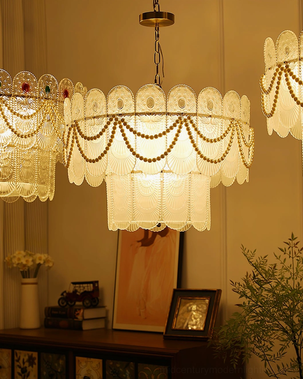 Two-tier scalloped glass chandelier showing full fixture composition with frosted glass shades, metal framework, and pearl bead decoration