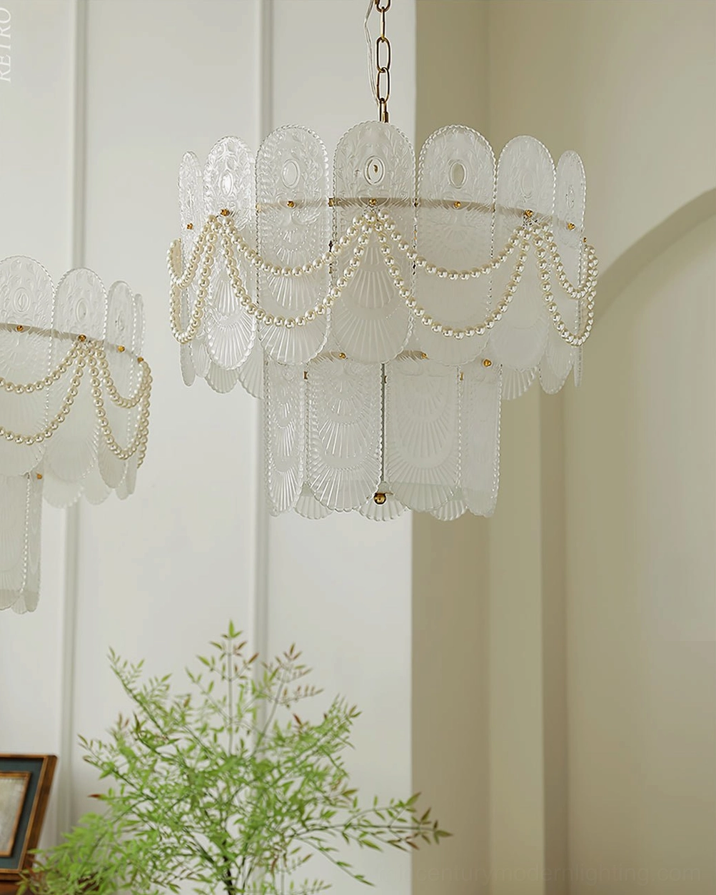 Complete two-tier scalloped glass chandelier with pearl bead swags and copper or white metal finish, lifestyle product photograph