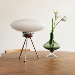 UFO table lamp displayed on wooden dining table with green glass vase, mid-century modern styling