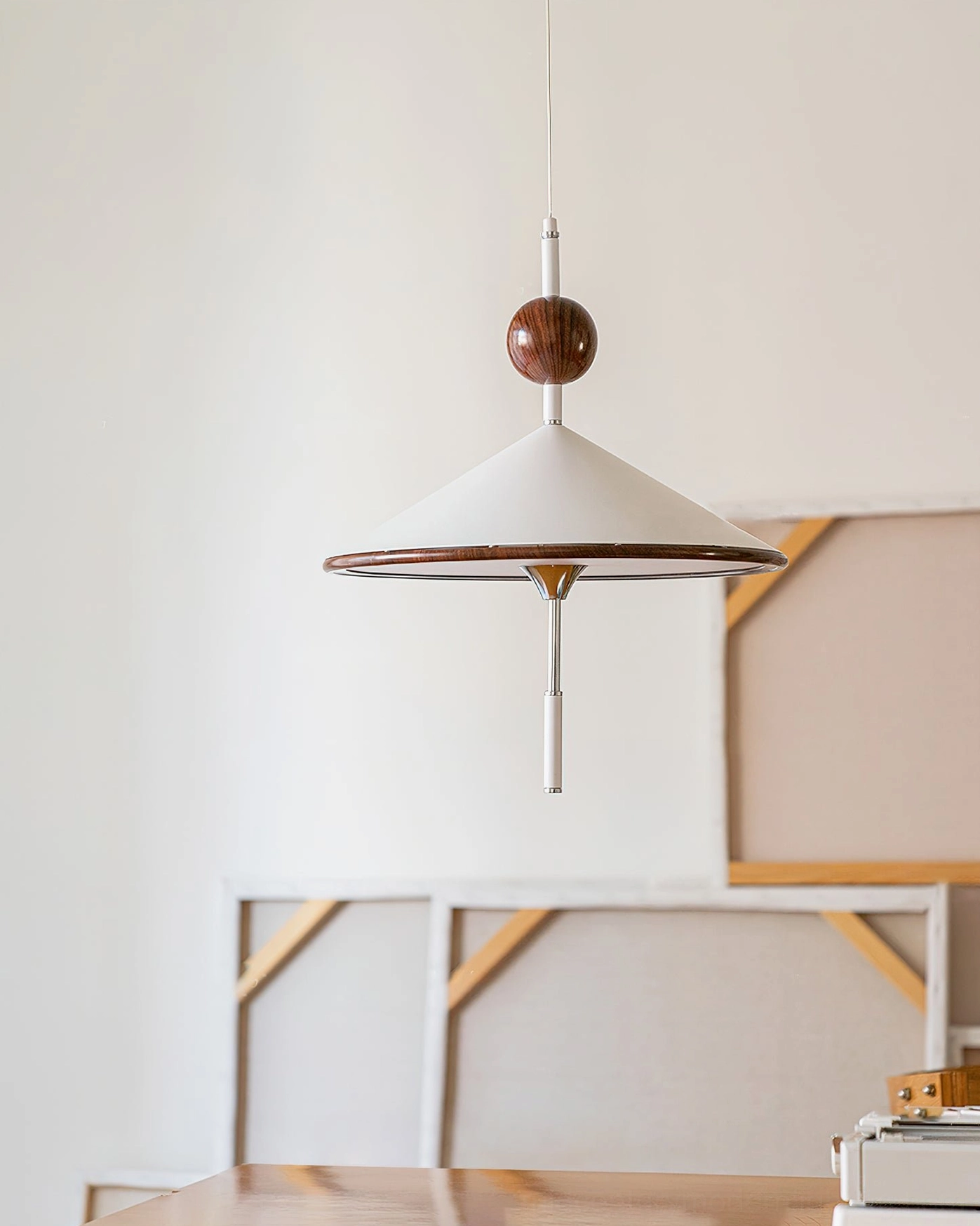 Unlit alien pendant light with slim metal rod suspension, frontal studio view