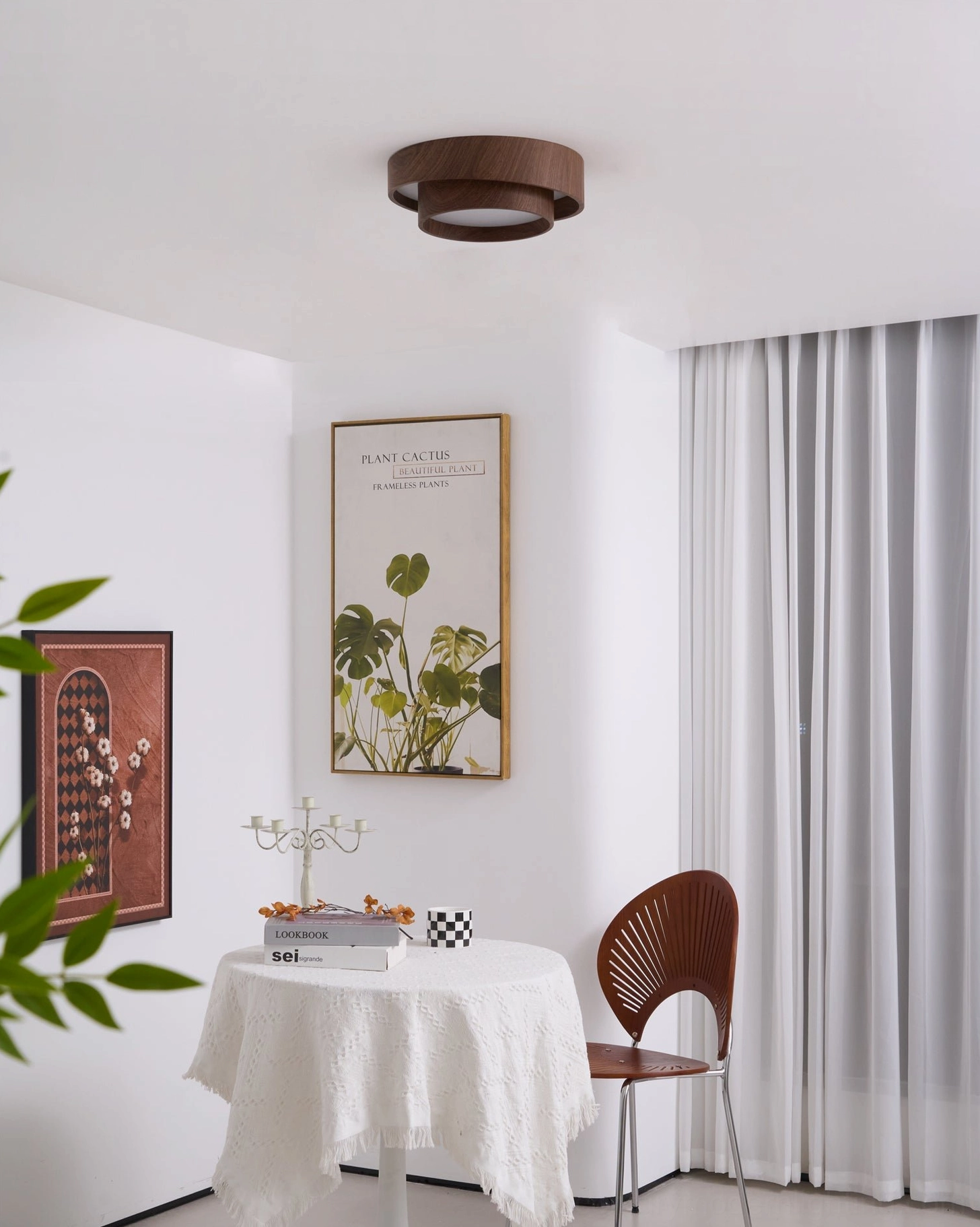 Vaako unlit ceiling lamp corner view in dark minimalist dining area with walnut finish and gallery wall art