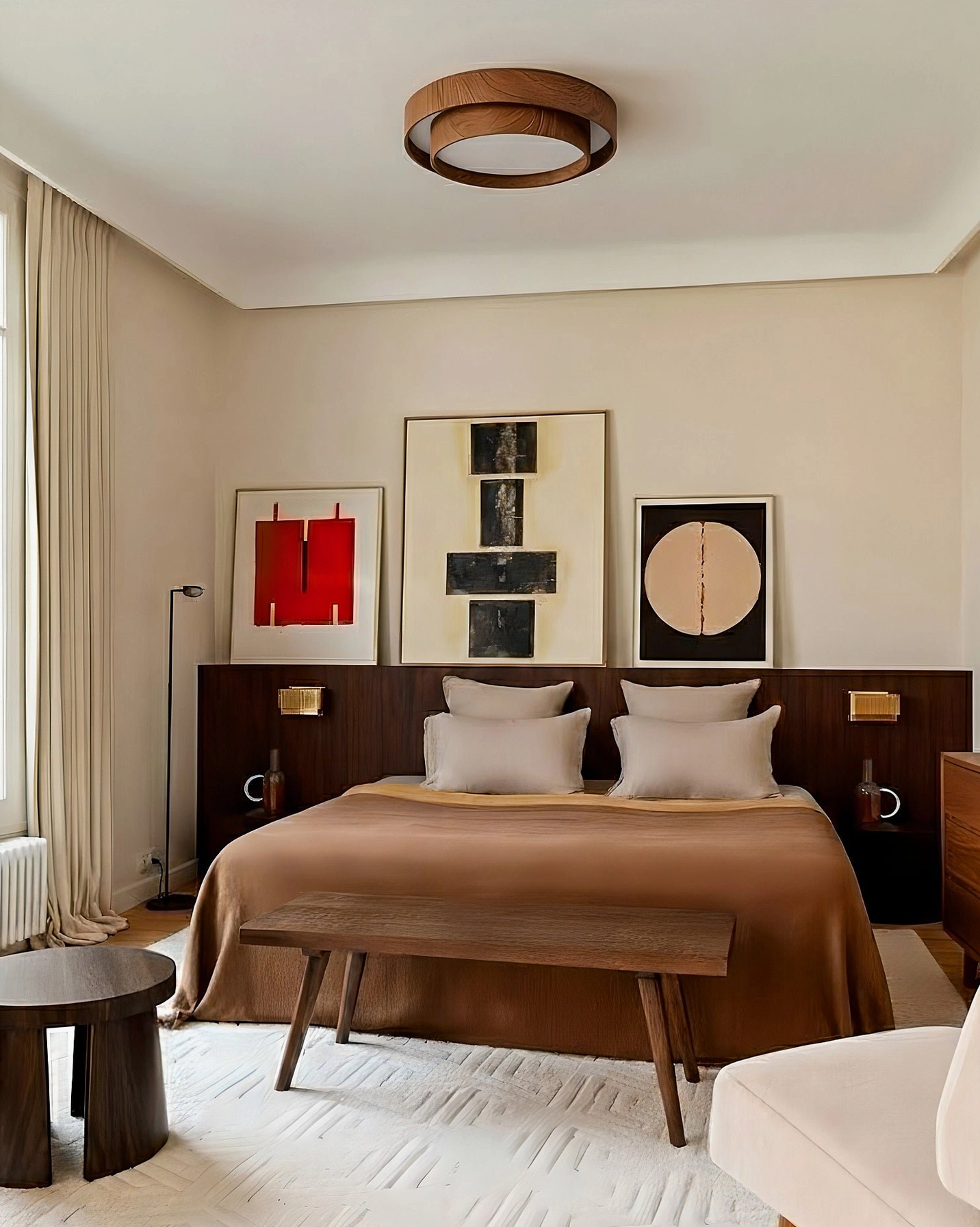 Vaako mounted ceiling lamp in modern bedroom with gallery wall creating warm ambient lighting for sleeping space