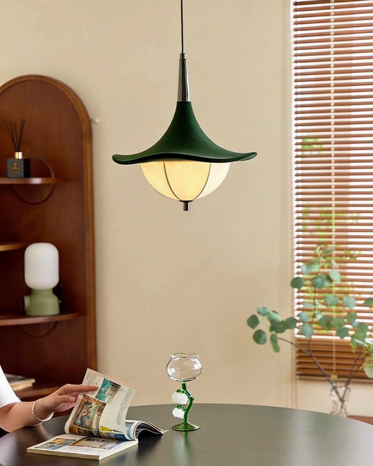Vadar pendant light hanging above cozy mid-century dining table with vintage accessories and plant