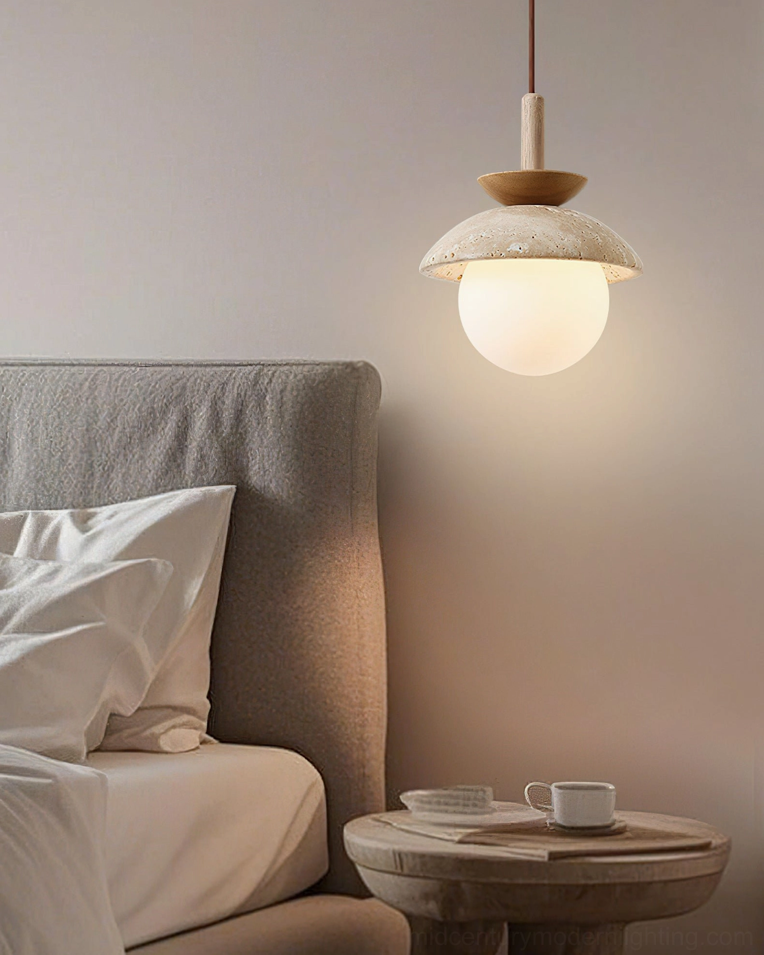 Single Valerie pendant light glowing softly beside bedroom bed creating warm ambient lighting for bedside reading