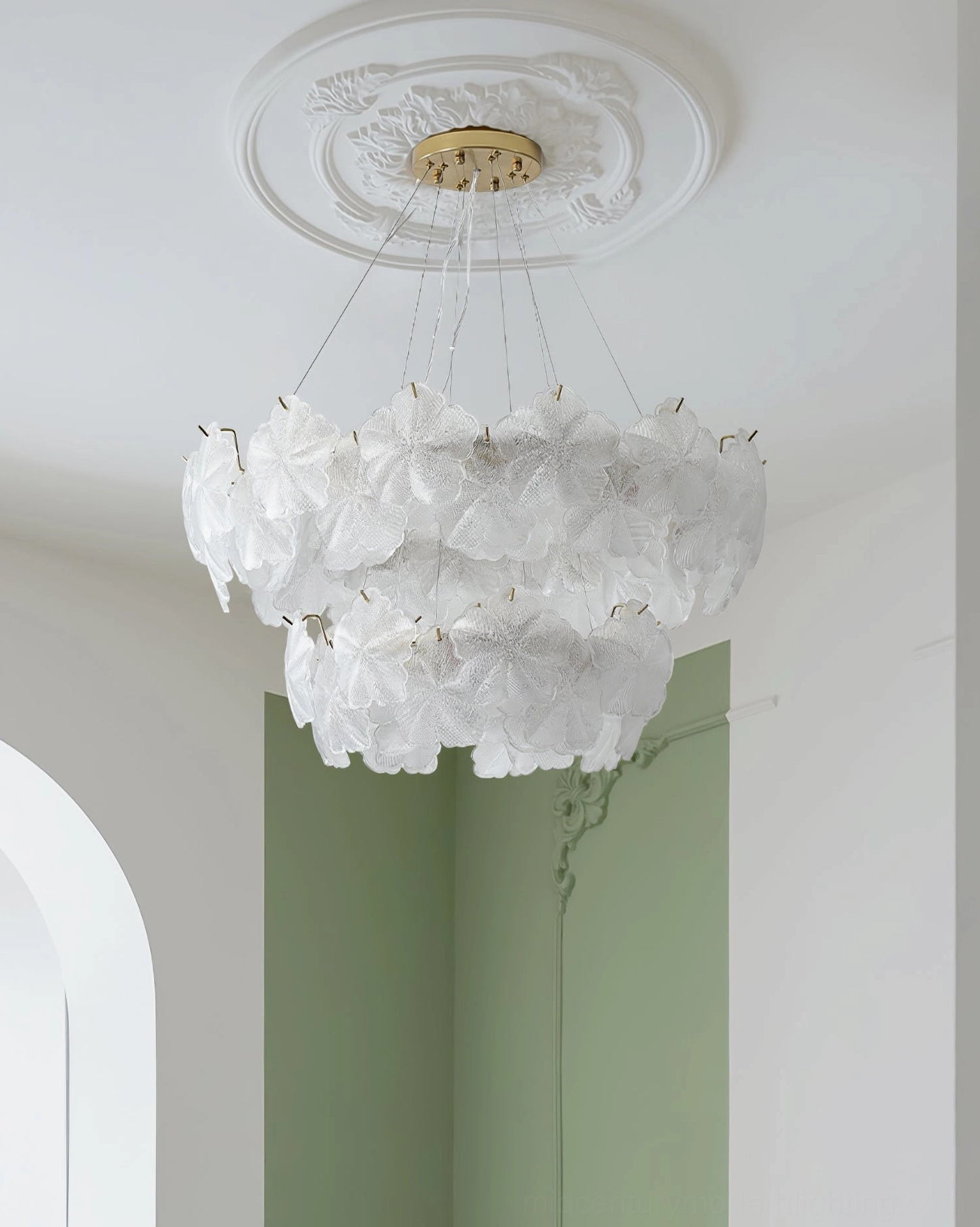 All-white Valery two-tier chandelier with green accent wall and ceiling medallion