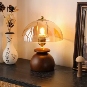 Valeska lamp styled on vintage entryway console with decorative vase, framed art, and mushroom ornament