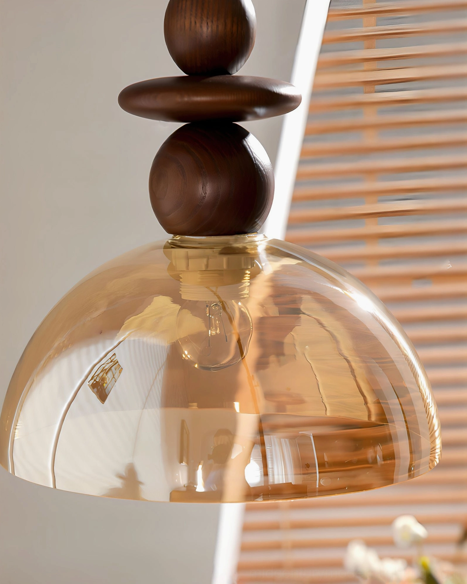 Valeska pendant light eye-level view with ambient window lighting and decorative home accessories