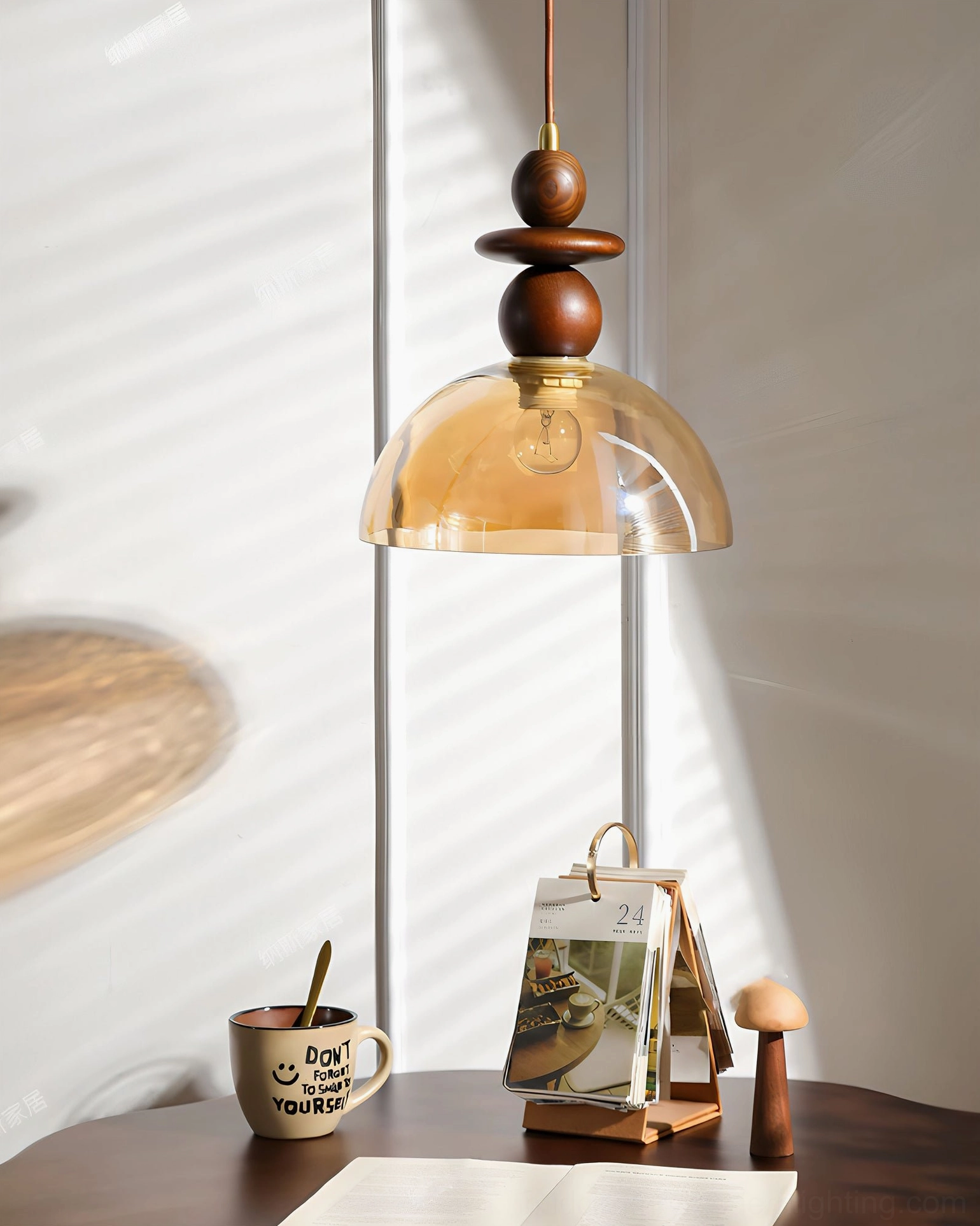 Valeska pendant light close-up detail view over wooden table with home decor accents and window light