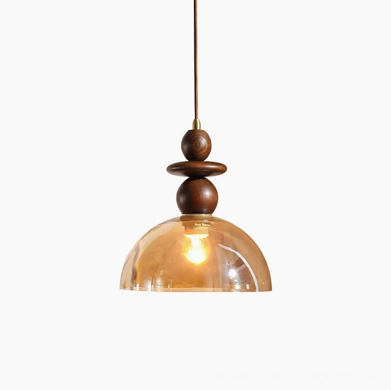 Valeska single light pendant with amber glass dome and walnut wood frame in warm setting